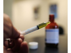 A syringe loaded with a dose of CBD oil is shown in a research laboratory at Colorado State University in Fort Collins, Colo., on November 6, 2017. The Canadian Hemp Trade Alliance and the Canadian Health Food Association are calling for changes to the regulatory environment for CBD and other hemp-derived cannabinoids.