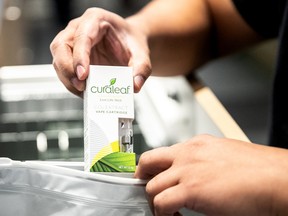 An employee puts a vape cartridge in a bag at a Curaleaf Inc. store in New York.