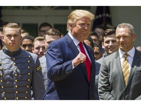 President Donald Trump pumps his fist as he departs after the presentation of the Commander-in-Chief's Trophy to the U.S. Military Academy at West Point football team, in the Rose Garden of the White House, Monday, May 6, 2019, in Washington.