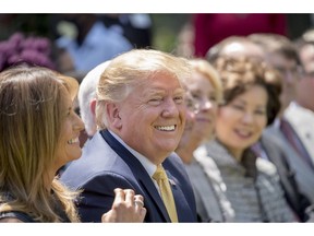 President Donald Trump and First lady Melania Trump, left, smile during a one year anniversary event for her Be Best initiative in the Rose Garden of the White House, Tuesday, May 7, 2019, in Washington.