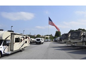 In this undated handout photo provided by Camping World, an American flag blows in the wind at Gander RV, in Statesville, N.C. Businessman and reality television star Marcus Lemonis says he'll go to jail before he removes a huge American flag flying at a recreational vehicle store that his company owns and that's the subject of a lawsuit because of its size.