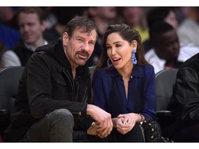 FILE - This March 6, 2019, file photo shows Henry T. Nicholas III, left, and Ashley Fargo during the second half of an NBA basketball game between the Los Angeles Lakers and the Denver Nuggets in Los Angeles. A hearing has been scheduled to decide if the California tech billionaire and victim rights advocate should stand trial on felony drug charges after authorities say he was found in a hotel room with briefcases full of drugs. Las Vegas Justice of the Peace Karen Bennett-Haron on Thursday, May 2, 2019, set a June 25 preliminary hearing of evidence in the case involving Broadcom Corp. co-founder Nicholas III and co-defendant Fargo.