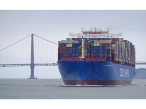 A Cosco Shipping container ship passes the Golden Gate Bridge Tuesday, May 14, 2019, in San Francisco bound for the Port of Oakland. The United States and China are raising tariffs on tens of billions of dollars' worth of each other's imports, escalating a trade war, spooking financial markets and casting gloom over the prospects for the world economy.