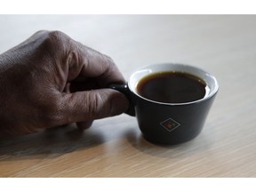 Klatch Coffee owner Bo Thiara holds a cup of Elida Natural Geisha coffee at his shop in San Francisco, Wednesday, May 15, 2019. The California cafe is brewing up what it calls the world's most expensive coffee - at $75 a cup. Klatch Coffee Roasters is serving the exclusive brew, the Elida Natural Geisha 803, at its branches in Southern California and San Francisco.