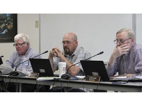 Three members of the Alaska Marijuana Control Board, chairman Mark Springer of Bethel, left, Nick Miller of Anchorage, center, and Loren Jones of Juneau, listen during the board's meeting Wednesday, May 1, 2019, in Anchorage, Alaska. One other member was unable to attend the three-day meeting, and one seat remains vacant.