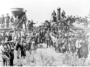 FILE - In this May 10, 1869, file photo, provided by the Union Pacific, railroad officials and employees celebrate the completion of the first railroad transcontinental link in Promontory, Utah. The completion of the Transcontinental Railroad was a pivotal moment in the United States, ushering in a period of progress and expansion nationwide. The Union Pacific's Locomotive No. 119, right, and Central Pacific's Jupiter edged forward over the golden spike that marked the joining of the nation by rail.