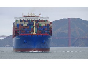 In this photo taken Tuesday, May 14, 2019, a container ship passes the Golden Gate Bridge in San Francisco bound for the Port of Oakland. Federal officials are promoting a campaign to get ships to slow down as they approach San Francisco and other California ports so they are less likely to injure or kill whales. The San Francisco Chronicle reported Friday, May 17, 2019, marine experts say four of the 10 gray whales found dead near San Francisco this year were killed by ships.