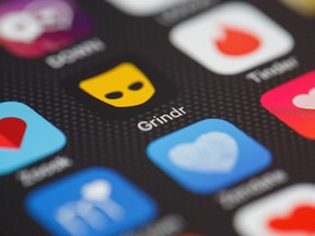 The "Grindr" app logo is seen amongst other dating apps on a mobile phone screen.