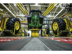 FILE - In this April 9, 2019, wheels are attach as workers assemble a tractor at John Deere's Waterloo, Iowa assembly plant. Deere & Co. reports earnings on Friday, May 17.