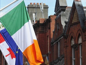 The Irish flag, right, European Union (EU) flag, center, and Canadian flag fly on Grafton Street in Dublin, Ireland.