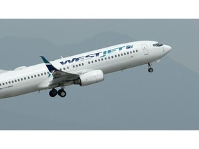 A WestJet plane takes off from Vancouver International Airport in Vancouver on Monday, May 13, 2019. Onex Corp.'s purchase of WestJet Airlines Ltd. has prompted Moody's Investors Service to place the carrier's credit rating under review for possible downgrade.