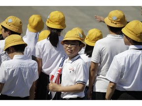 School children wait for President Donald Trump and first lady Melania Trump to arrive participate in a welcome ceremony at the Imperial Palace, Monday, May 27, 2019, in Tokyo.