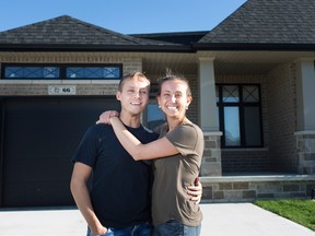 Andre Portovedo, left, and Danielle Bacci, who moved away from the Toronto area in January 2019, pose for a portrait in front of their new home in Kingsville, Ont.