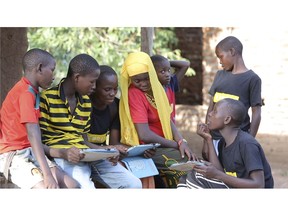 In this undated photo provided by XPRIZE, children in a village in the Tanga region of Tanzania gather to learn from tablets using open-sourced software that would easily be downloaded by illiterate children to teach themselves to read. That's what nearly 200 teams from around the world have spent more than a year in impoverished villages in Tanzania trying to do. The winner of this latest competition for a $10 million XPRIZE for global innovation is being announced Wednesday, May 15, 2019, in Los Angeles. (Courtesy XPRIZE via AP)