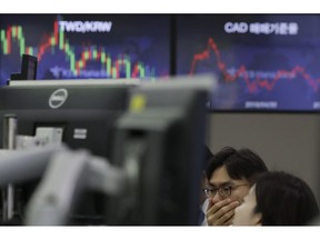 Currency traders watch the computer monitors near the screen showing the foreign exchange rate at the foreign exchange dealing room in Seoul, South Korea, Thursday, May 9, 2019. Asian shares were mostly lower Thursday amid investor jitters ahead of the latest round of trade talks between the U.S. and China.
