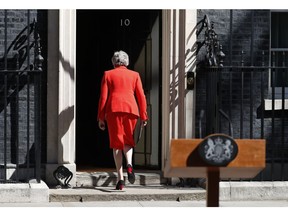 FILE - In this Friday, May 24, 2019 file photo, British Prime Minister Theresa May walks away after announcing her resignation, outside 10 Downing Street in London, England. British Prime Minister Theresa May has announced she will step down as leader of the Conservative Party on June 7, starting a process that will lead to a Conservative Party leadership contest and a new British prime minister who will lead the government during the Brexit process.