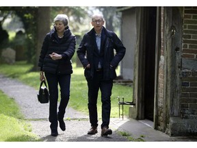 Britain's Prime Minister Theresa May with her husband Philip leave after a church service near her Maidenhead constituency, England, Sunday May 19, 2019.