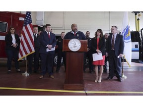 Lawrence, Mass. Mayor Dan Rivera, center, addresses reporters during a news conference announcing a settlement following last years' gas explosions in three communities in the Merrimack Valley, at the Public Safety Building in Andover, Mass., Tuesday, May 7, 2019. Columbia Gas, the utility blamed for a series of natural gas explosions in Massachusetts in September 2018, has agreed to pay $80 million to Lawrence, Andover and North Andover to cover the costs of repairing roads and other infrastructure torn up during restoration efforts.