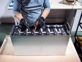 An employee performs a final test on a bank of lithium ion batteries at the Electrovaya Inc. headquarters in Mississauga, Ont.