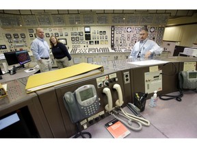 Control Room Supervisor Bob Sheridan, of Duxbury, Mass., left, and Senior Reactor Operator Kelly Connerton, of Middleborough, Mass., center, stand together in the Control Room Simulator moments before a simulated reactor shutdown, Tuesday, May 28, 2019, at a training facility several miles from the Pilgrim Nuclear Power Station, in Plymouth, Mass. The simulated shutdown was performed in front of members of the media ahead of the planned actual shutdown of the aging reactor on Friday, May 31.