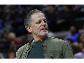 FILE- In an Oct. 12, 2018 file photo, Quicken Loans and Rock Ventures founder Dan Gilbert is seen during a basketball game in East Lansing, Mich. Gilbert is starting a ballot drive as a "failsafe" in case Michigan's Republican-led Legislature and Democratic Gov. Gretchen Whitmer don't enact legislation to cut the country's highest auto insurance premiums. Quicken Loans vice president of government affairs Jared Fleisher said Monday that a ballot committee, Citizens for Lower Auto Insurance Rates, will be created this week.