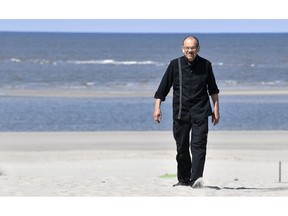 In this photo taken on Wednesday, May 15, 2019, Restaurateur Michael Recktenwald, who has taken legal action against the EU to protect climate walks on the beach near his restaurant, poses for the media on the car-free environmental island of Langeoog in the North Sea, Germany. Concerns about climate change have prompted mass protests across Europe for the past year and are expected to draw tens of thousands onto the streets again Friday, May 24. For the first time, the issue is predicted to have a significant impact on this week's elections for the European Parliament.
