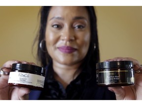 In this Monday, May 6, 2019, photo Jamie Masters shows her beauty products with the new labeling, at left, and old labeling, at right, in her home in Kansas City, Mo. At first Masters sold her products under the name Trinite Organiques, but people didn't know how to pronounce it and they didn't understand the name. After changing the name to 826 & Co., sales are picking up.