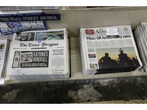 FILE - In this Thursday, Sept. 27, 2012 file photo, free introductory copies of the Baton Rouge Advocate's new New Orleans edition, right, are seen next to copies of the New Orleans Times-Picayune at Lakeside News in the New Orleans suburb of Metairie, La. The owners of Louisiana's The Advocate newspaper have purchased The Times-Picayune in New Orleans from Advance Local Media. The Advocate announced the purchase on its website Thursday, May 2, 2019.