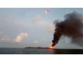 FILE - This Friday. Oct. 20, 2017 photo provided by the U.S. Coast Guard shows a barge on fire approximately three miles from Port Aransas, Texas. In a report released on April 18, 2019, federal investigators concluded that the deadly blast resulted from the lack of effective maintenance and safety management of the barge. (U.S. Coast Guard via AP)