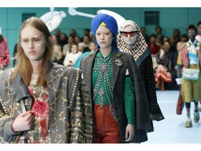 FILE - In this Feb. 21, 2018 file photo, models display items from Gucci's women's Fall/Winter 2018-2019 collection, presented during the Milan Fashion Week, in Milan, Italy. The top civil rights organization for Sikhs in the United States says Nordstrom has apologized to the community for selling an $800 turban they found offensive, but they are still waiting to hear from the Gucci brand that designed it, Saturday, May 18, 2019.