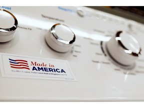 In this May 9, 2019, photo a General Electric washing machine with a label advertising it was made in America is displayed in retail stores in Cranberry Township, Pa. China has announced tariff hikes on $60 billion of U.S. goods in retaliation for President Donald Trump's escalation of a fight over technology and other trade disputes. The Finance Ministry said Monday, May 13, the penalty duties of 5% to 25% on hundreds of U.S. products including batteries, spinach and coffee take effect June 1.