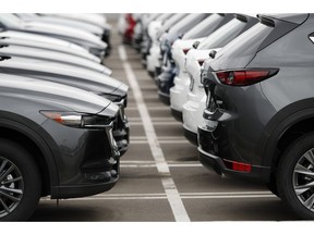 FILE - In this Sunday, May 19, 2019, file photo lines of unsold 2019 CX-5 sports-utility vehicles sit at a Mazda dealership in Littleton, Colo. On Tuesday, May 28, the Conference Board releases its May index on U.S. consumer confidence.