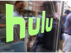 FILE - This June 27, 2015, file photo, shows the Hulu logo on a window at the Milk Studios space in New York. Disney has struck a deal with Comcast that gives it full control of streaming service Hulu. The companies said Tuesday, May 14, 2019, that as early as January 2024 Comcast can require Disney to buy NBCUniversal's 33% interest in Hulu and Disney can require NBCUniversal to sell that stake to Disney for its fair market value at that future time.