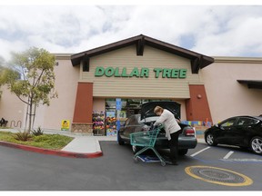 FILE - In this May 26, 2016, file photo, a shopper searches her purse outside a Dollar Tree store in Encinitas, Calif. Dollar Tree, Inc. reports financial results Thursday, May 30, 2019.