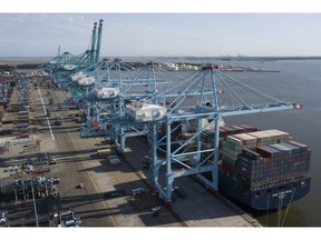 FILE - In this May 10, 2019, file photo a container ship is unloaded at the Virginia International Gateway terminal in Norfolk, Va. On Thursday, May 30, the Commerce Department issues the second estimate of how the U.S. economy performed in the January-March quarter.