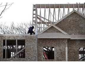 FILE - In this Jan. 23, 2019, file photo, construction workers build new housing in Salisbury, Mass. On Thursday, May 16, the Commerce Department reports on U.S. home construction in April.