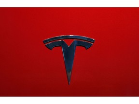 FILE- This Oct. 3, 2018, file photo shows the logo of Tesla model 3 at the Auto show in Paris. The National Transportation Safety Board says Tesla's Autopilot semi-autonomous driving system was in use when one of its cars drove beneath a semitrailer in Florida in March, killing the driver.