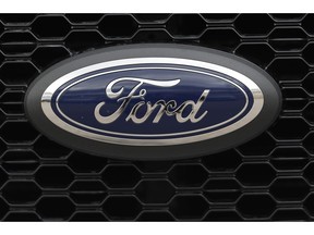 FILE- In this Feb. 17, 2019, file photo the company logo is displayed on the grille of an unsold 2019 F150 pickup truck at a Ford dealership in Broomfield, Colo. Ford is almost finished with a major global restructuring, and by the time it ends in August the automaker will have shed 7,000 white-collar jobs. The company said Monday, May 20 that the plan will save about $600 million per year by eliminating bureaucracy and increasing the number of workers reporting to each manager.
