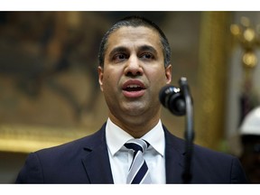 FILE - In this April 12, 2019 file photo, Federal Communications Commission Chairman Ajit Pai speaks during an event with President Donald Trump on the deployment of 5G technology in the United States, in the Roosevelt Room of the White House, in Washington. Pai says he plans to recommend the agency approve the $26.5 billion merger of wireless carriers T-Mobile and Sprint, saying it'll speed up 5G deployment in the U.S. Pai also said Monday, May 20 that the combination will help bring faster mobile broadband to rural Americans.