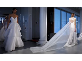 FILE - This April 12, 2019 file photo shows fashion from the Amsale bridal collection in New York. Bridal sites TheKnot.com, WeddingWire.com and Spanish-language Bodas.net released a report on wedding trends and traditions worldwide.