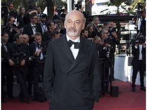 FILE - This May 28, 2017 file photo shows Christian Louboutin at the award ceremony at the 70th international Cannes Film festival in Cannes, France. Louboutin and his famous towering, red-soled shoes are being awarded a prestigious fashion honor. The French designer will be the next honoree of the Couture Council of the Museum at the Fashion Institute of Technology. The annual award is given in early September, launching New York Fashion Week.