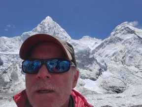 This April 2019 selfie photo provided by Mark Kulish shows his brother Christopher Kulish beneath Mount Everest. Christopher Kulish, a Colorado climber, died shortly after getting to the top of Mount Everest and achieving his dream of scaling the highest peaks on each of the seven continents, his brother said Monday, May 27.