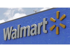 FILE - This June 1, 2017, file photo, shows a Walmart sign at a store in Hialeah Gardens, Fla. Walmart is rolling out next-day delivery on its most popular items, raising the stakes in the retail shipping wars. The nation's largest retailer says Tuesday, May 13, 2019, it's been building its own network of more efficient e-commerce distribution centers to enable the faster delivery.