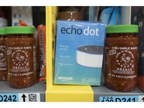 FILE - This Dec. 20, 2017, file photo shows the Amazon Echo Dot stocked on a shelf alongside jars of Garlic Chili Sauce at the Amazon Prime warehouse in New York. Consumer advocates say the kids' version of Amazon's Alexa won't forget what children tell it, even after parents try to delete the conversations. A coalition of groups on Thursday, May 9, 2019, is planning to ask the Federal Trade Commission to investigate whether Amazon is holding onto children's voice recordings and personal information longer than it should.
