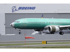 FILE - In this April 10, 2019, file photo a Boeing 737 MAX 8 airplane being built for India-based Jet Airways lands following a test flight at Boeing Field in Seattle. The grounding of Boeing 737 Max jets likely means that fare increases this summer will be larger than already expected and airlines will struggle to handle disruptions such as storms that shut down hub airports.