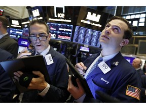 FILE - In this May 9, 2019, file photo traders Gregory Rowe and Benjamin Tuchman work on the floor of the New York Stock Exchange. The U.S. stock market opens at 9:30 a.m. EDT on Wednesday, May 15.