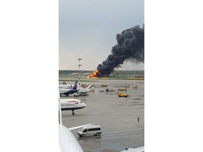 In this image provided by Riccardo Dalla Francesca shows smoke rises from a fire on a plane at Moscow's Sheremetyevo airport on Sunday, May 5, 2019.