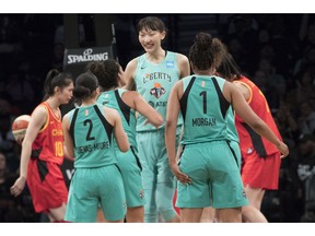 New York Liberty center Han Xu, center, celebrates her goal with her teammates during the second half of the team's WNBA exhibition basketball game against China, Thursday, May 9, 2019, in New York.