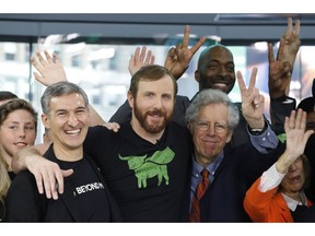 Ethan Brown, center, CEO of Beyond Meat, attends the Opening Bell ceremony to celebrate the company's IPO at Nasdaq, Thursday, May 2, 2019 in New York. California-based Beyond Meat makes burgers and sausages out of pea protein and other ingredients.