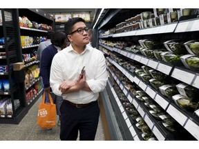 A customer shops in a newly-opened Amazon Go store, Tuesday, May 7, 2019 in New York. The store will be the first Amazon Go store to accept cash. At its other shops, customers can only enter with an app that links to a credit card or an Amazon account.
